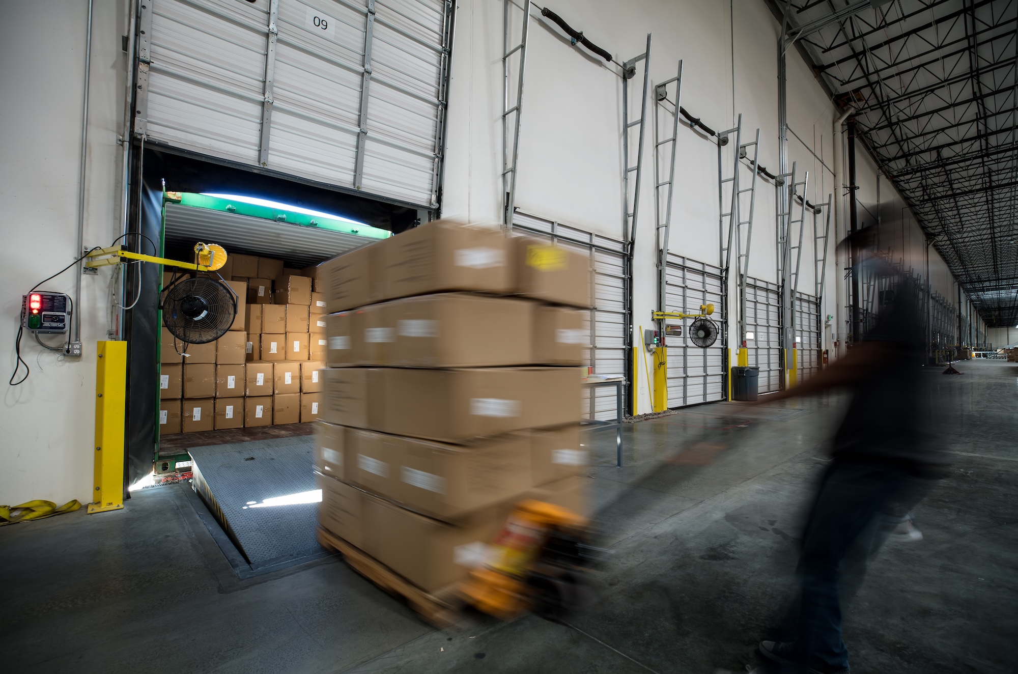 Complete Warehouse Providers - cross-docking - Worker Unloading Truck at Warehouse Loading Dock