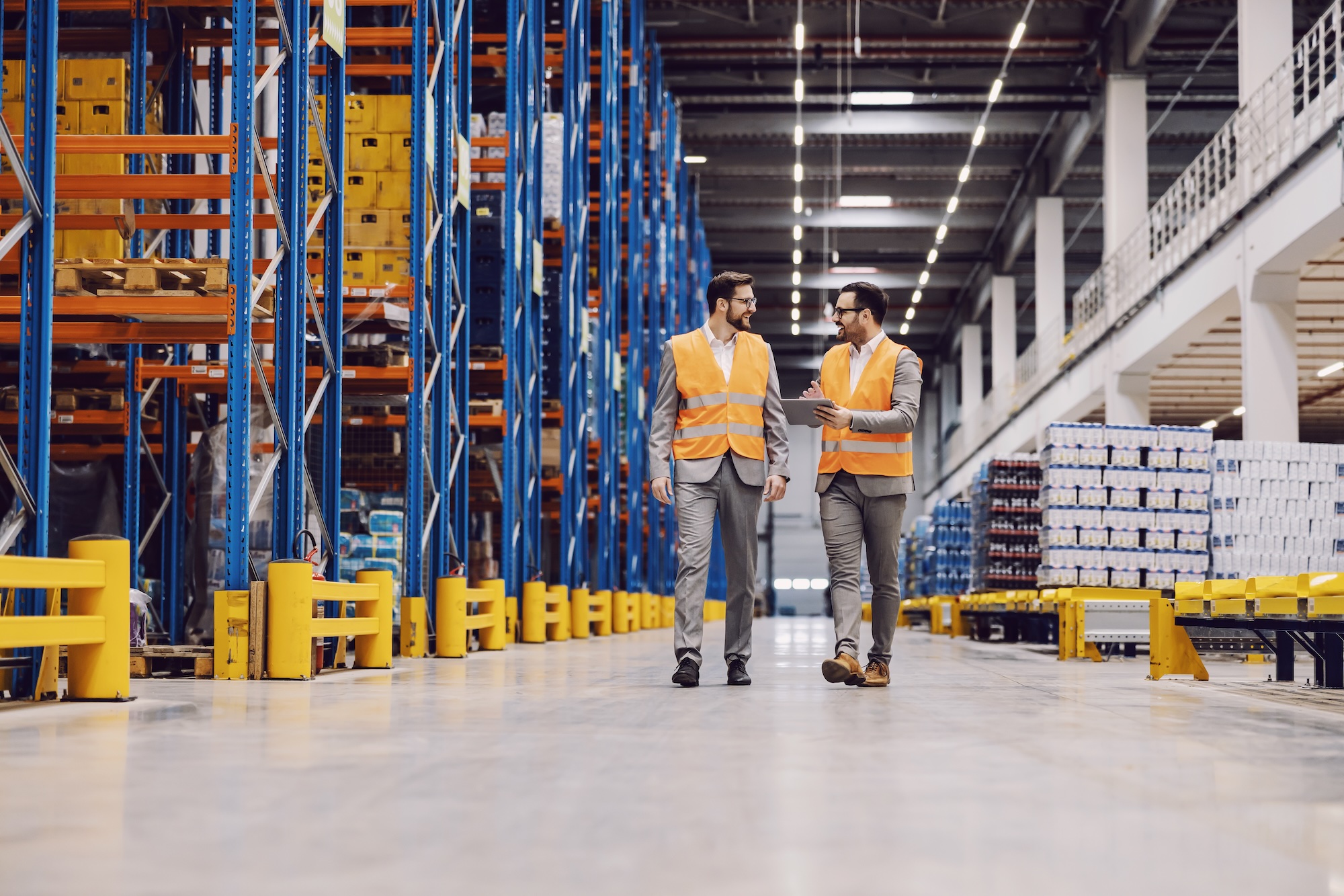 Complete Warehouse providers - men walk through warehouse looking at storage